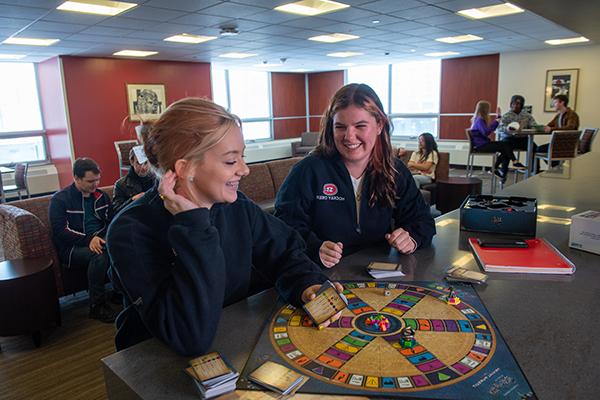 Students playing board game 